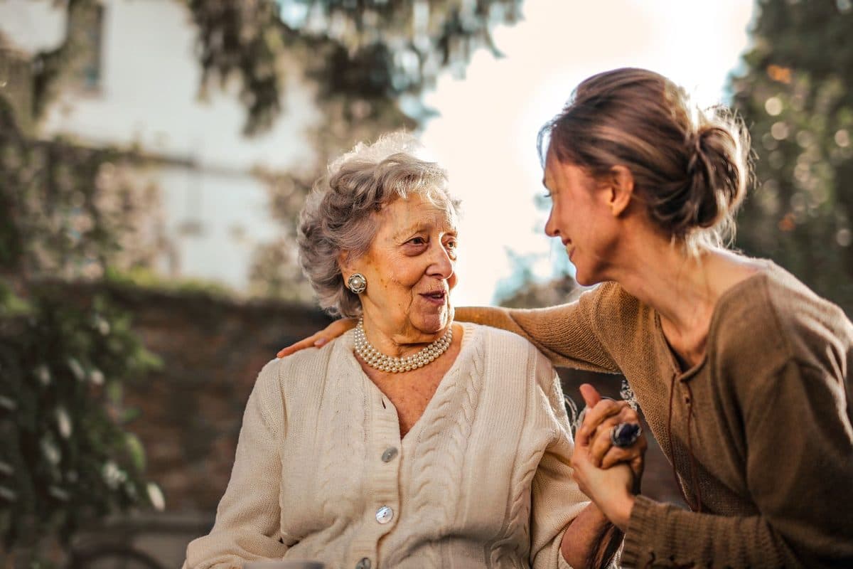 Illustrative stock photo of an older adult and a companion outdoors — models are not Amity clients or employees